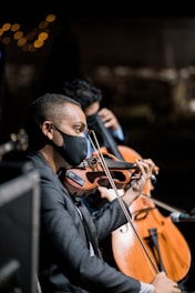 man in black long sleeve shirt playing violin