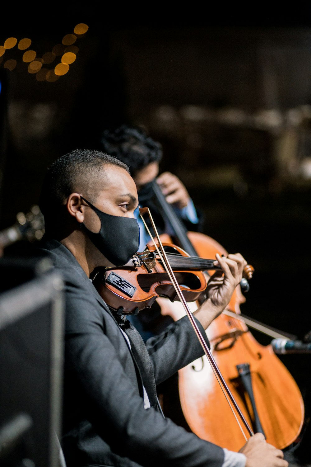 man in black long sleeve shirt playing violin