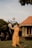 woman in brown dress holding white balloons