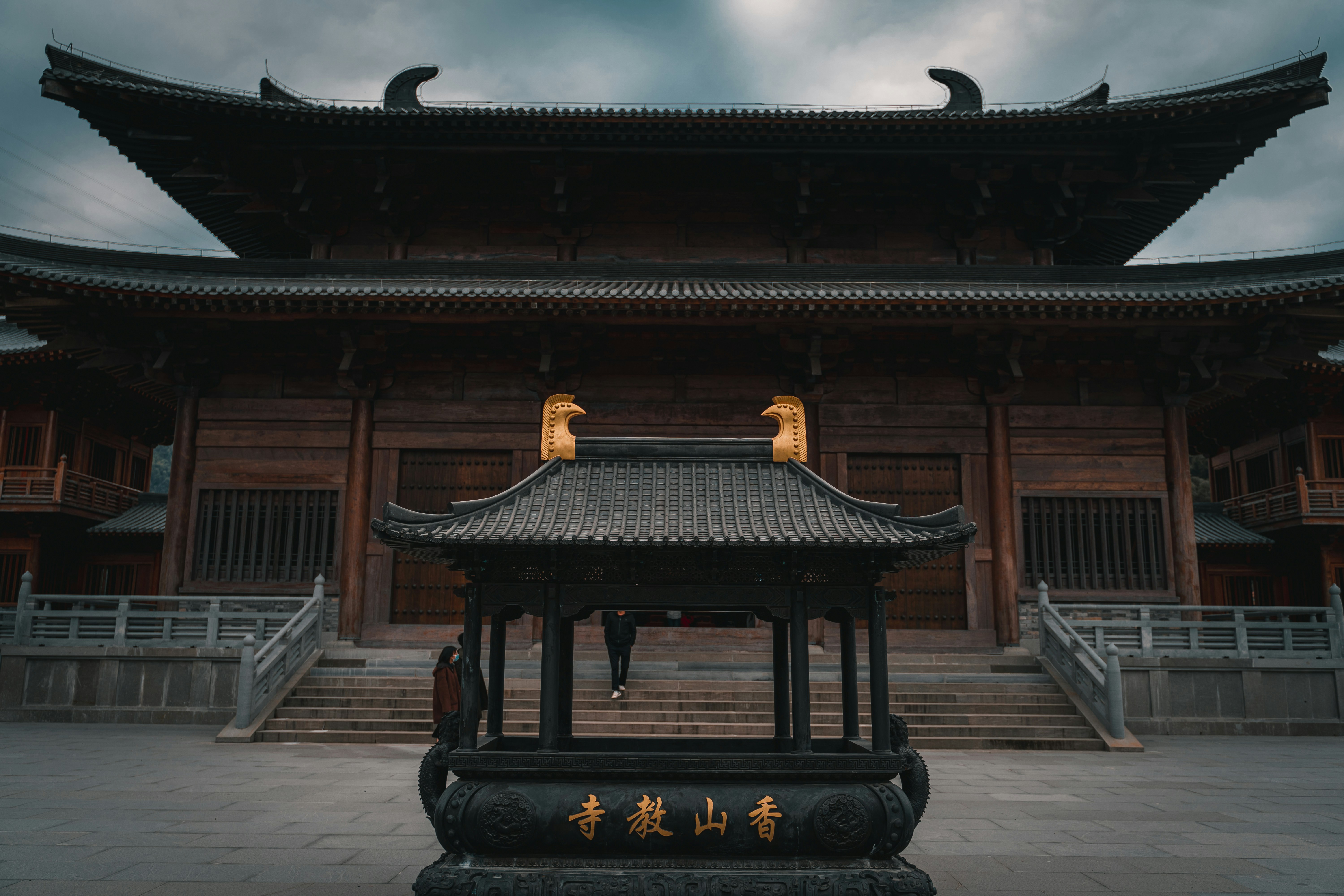 brown wooden building under white clouds during daytime