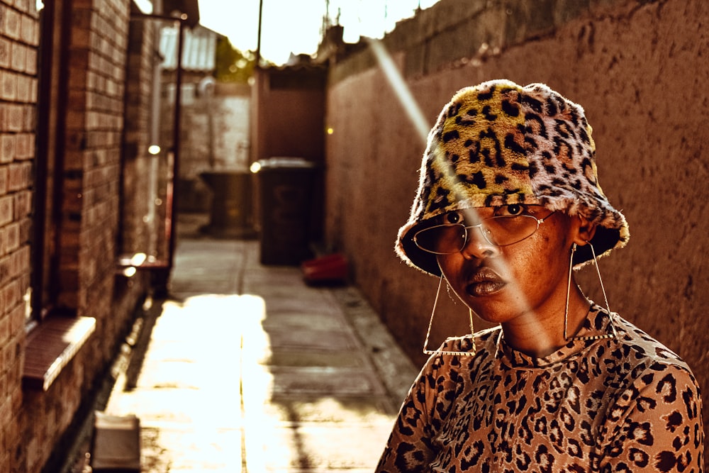 woman in white and black leopard print shirt wearing white knit cap