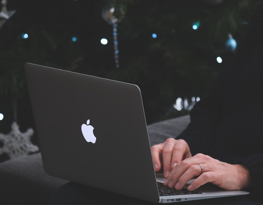 person using macbook air during nighttime