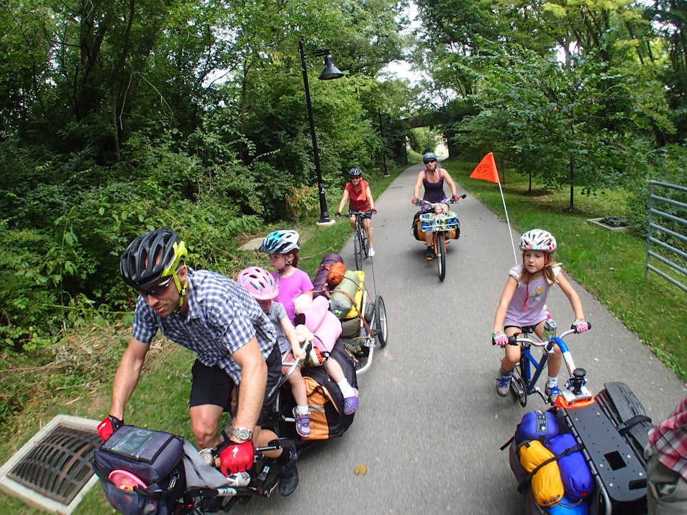 people riding bicycle on road during daytime