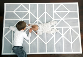 Kids playing cooperative games on a colorful play mat.