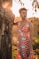 girl in red and white polka dots sleeveless dress standing beside brown tree during daytime