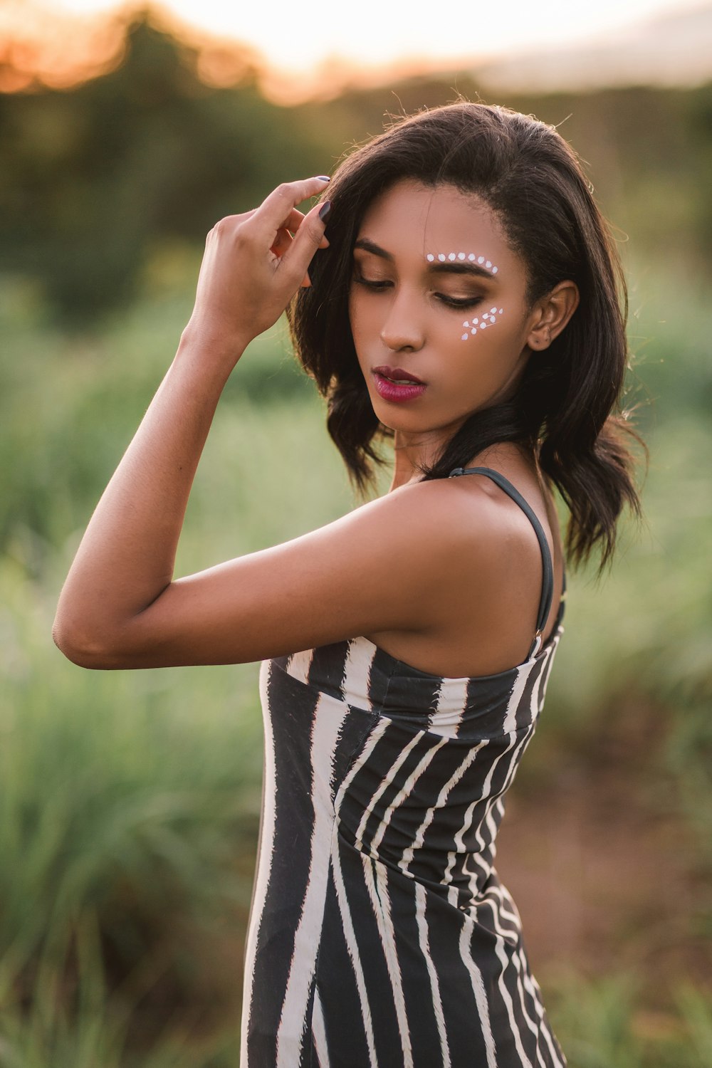 woman in black and white stripe tank top