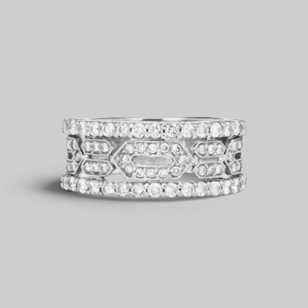 A silver band ring adorned with multiple small, sparkling diamonds arranged in a geometric pattern. The design exhibits a blend of intricate craftsmanship and elegance, featuring two outer rows and an elaborate center section with diamond settings.