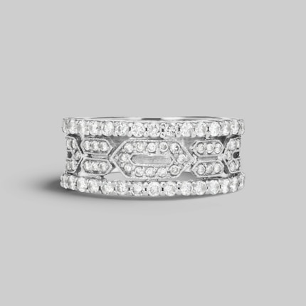 A silver band ring adorned with multiple small, sparkling diamonds arranged in a geometric pattern. The design exhibits a blend of intricate craftsmanship and elegance, featuring two outer rows and an elaborate center section with diamond settings.