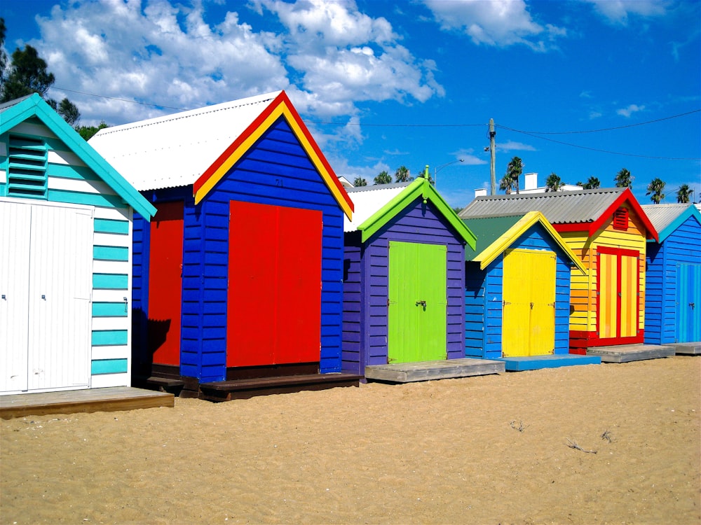 red blue and green wooden houses under blue sky during daytime