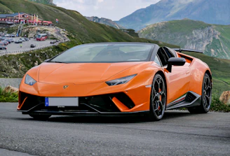 orange lamborghini aventador on road during daytime