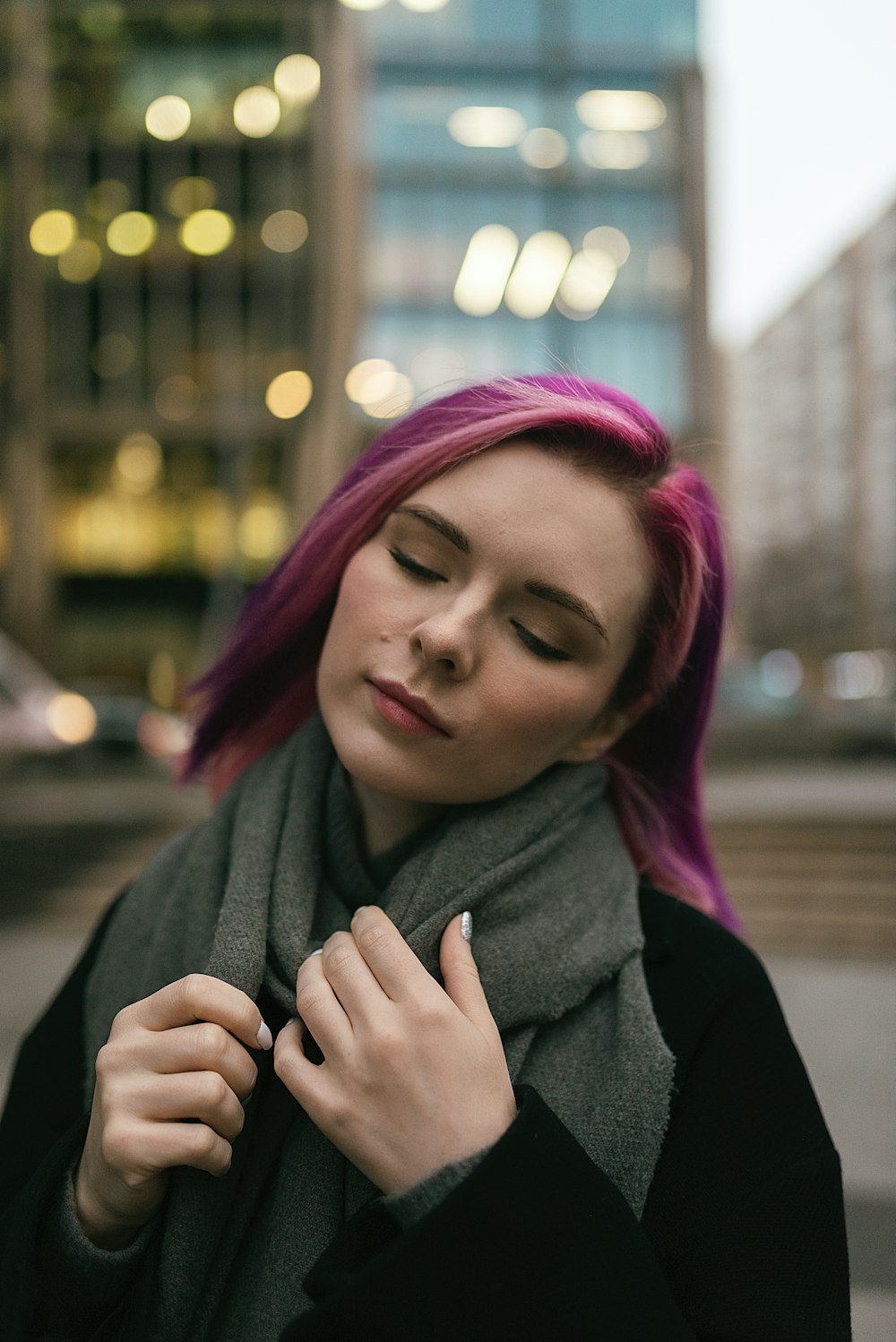 woman in black coat with red hair