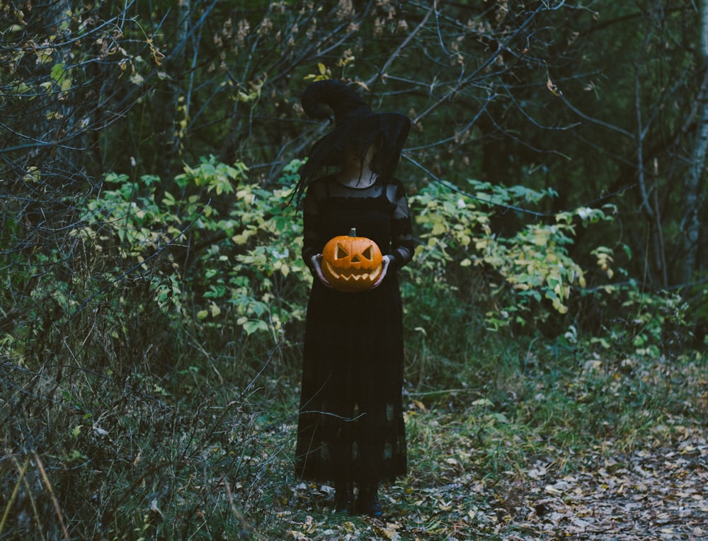 woman in black dress standing on green grass field