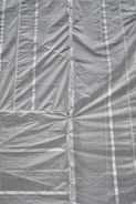 A close-up of durable plastic sheeting covering a construction site foundation.