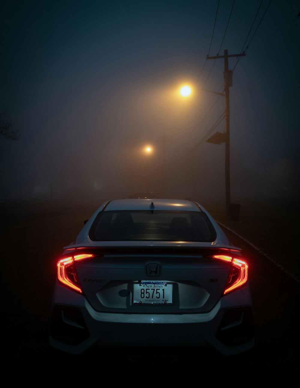 white honda car on road during night time