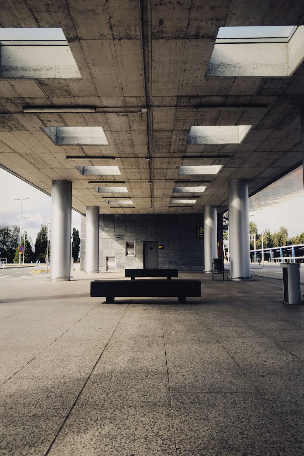 an empty parking garage with a bench in the middle