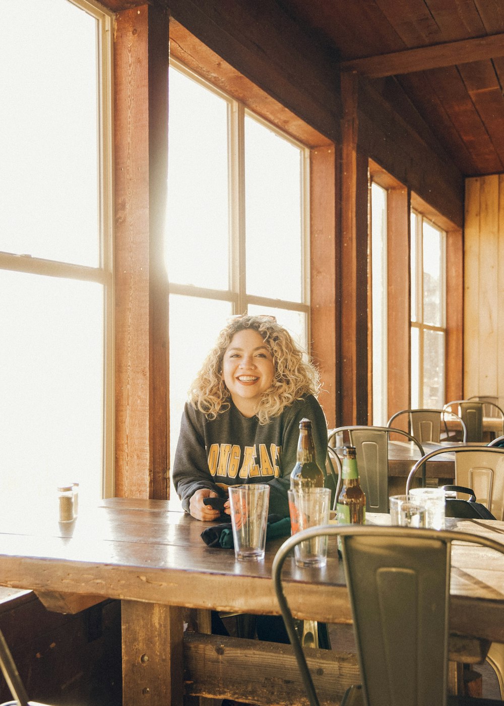 woman in gray long sleeve shirt sitting on chair