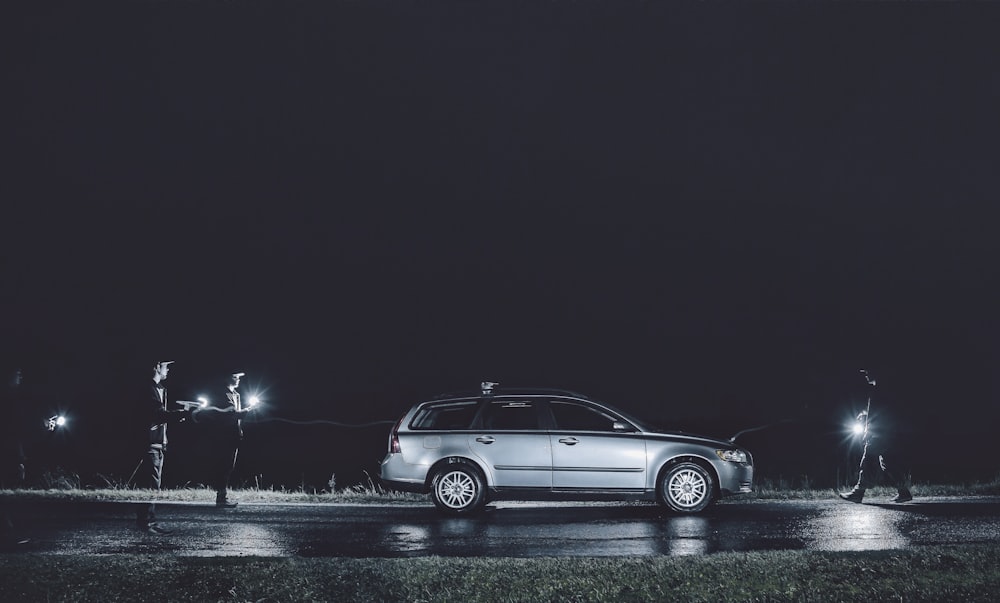 gray sedan on road during night time