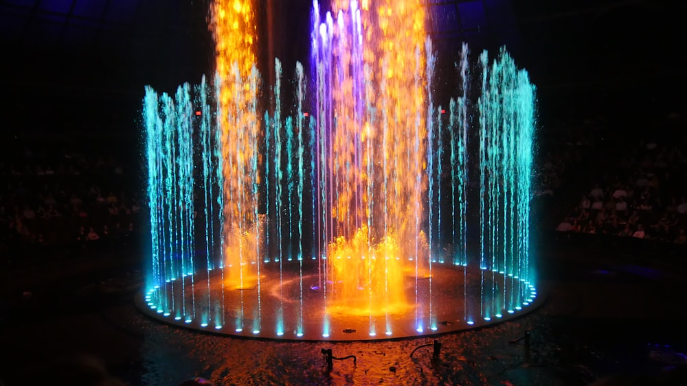 water fountain with lights turned on during night time