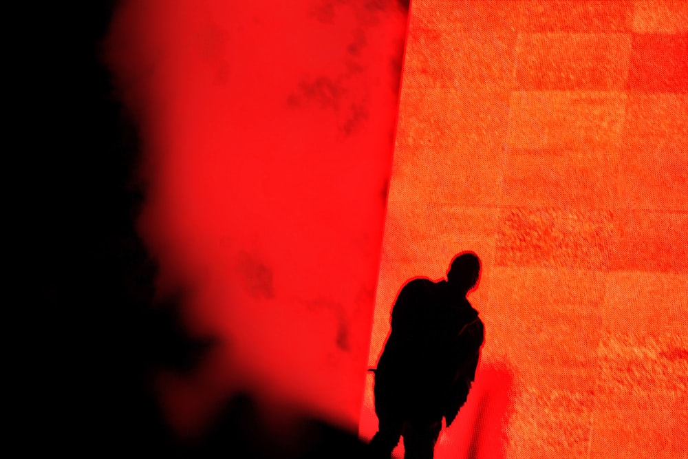 silhouette of man and woman standing on the street