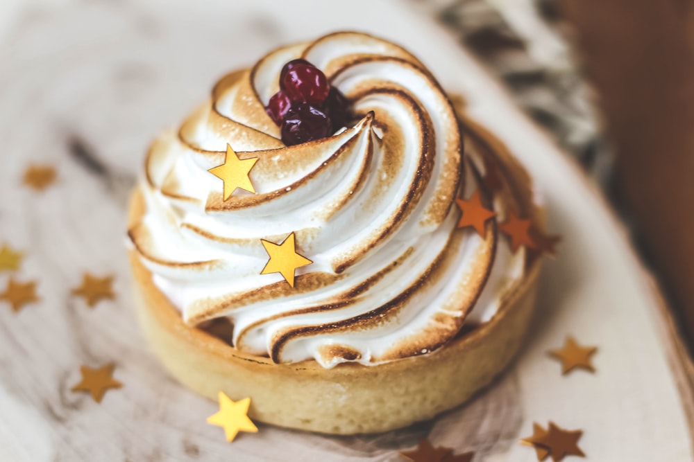 brown and white cupcake with white icing on top