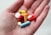 orange and white medication pill on persons hand
