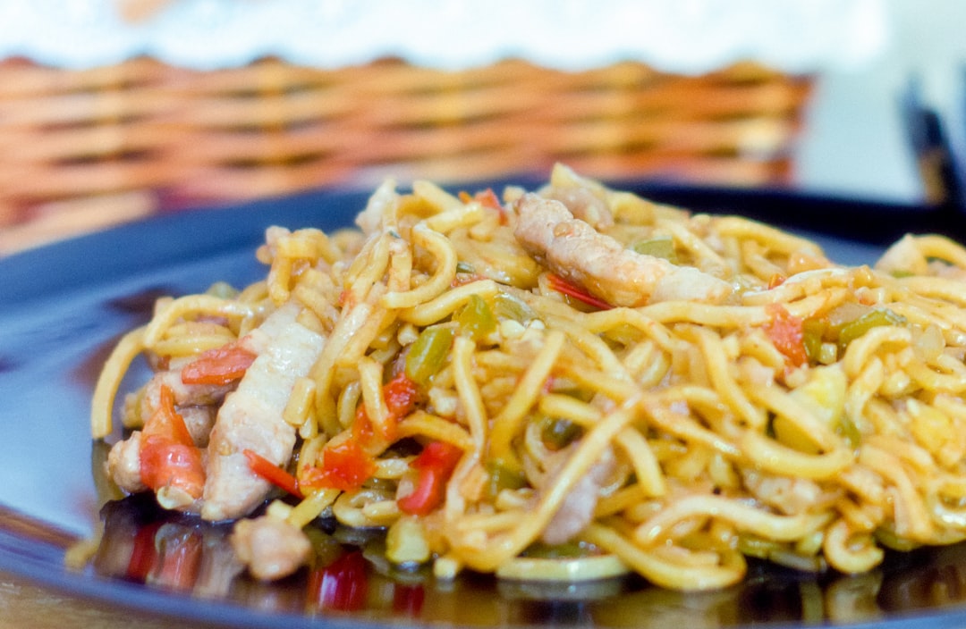 pasta dish on brown ceramic plate, fish noodles