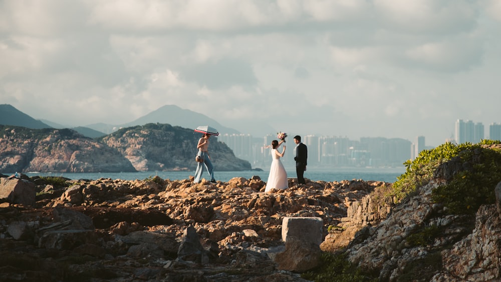 couple standing on rock formation during daytime