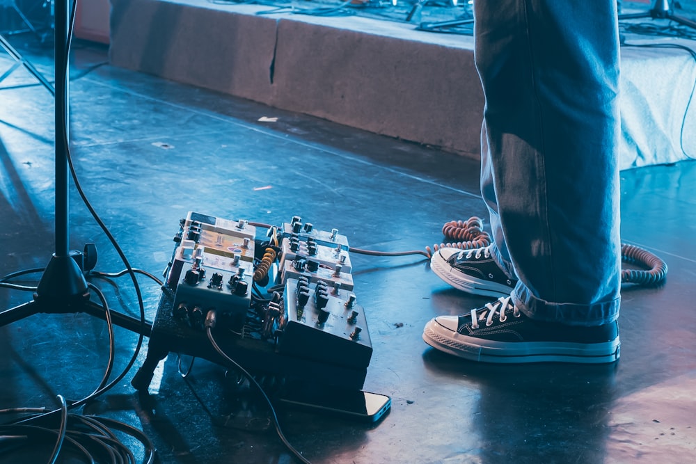 person in black and white sneakers standing on white floor