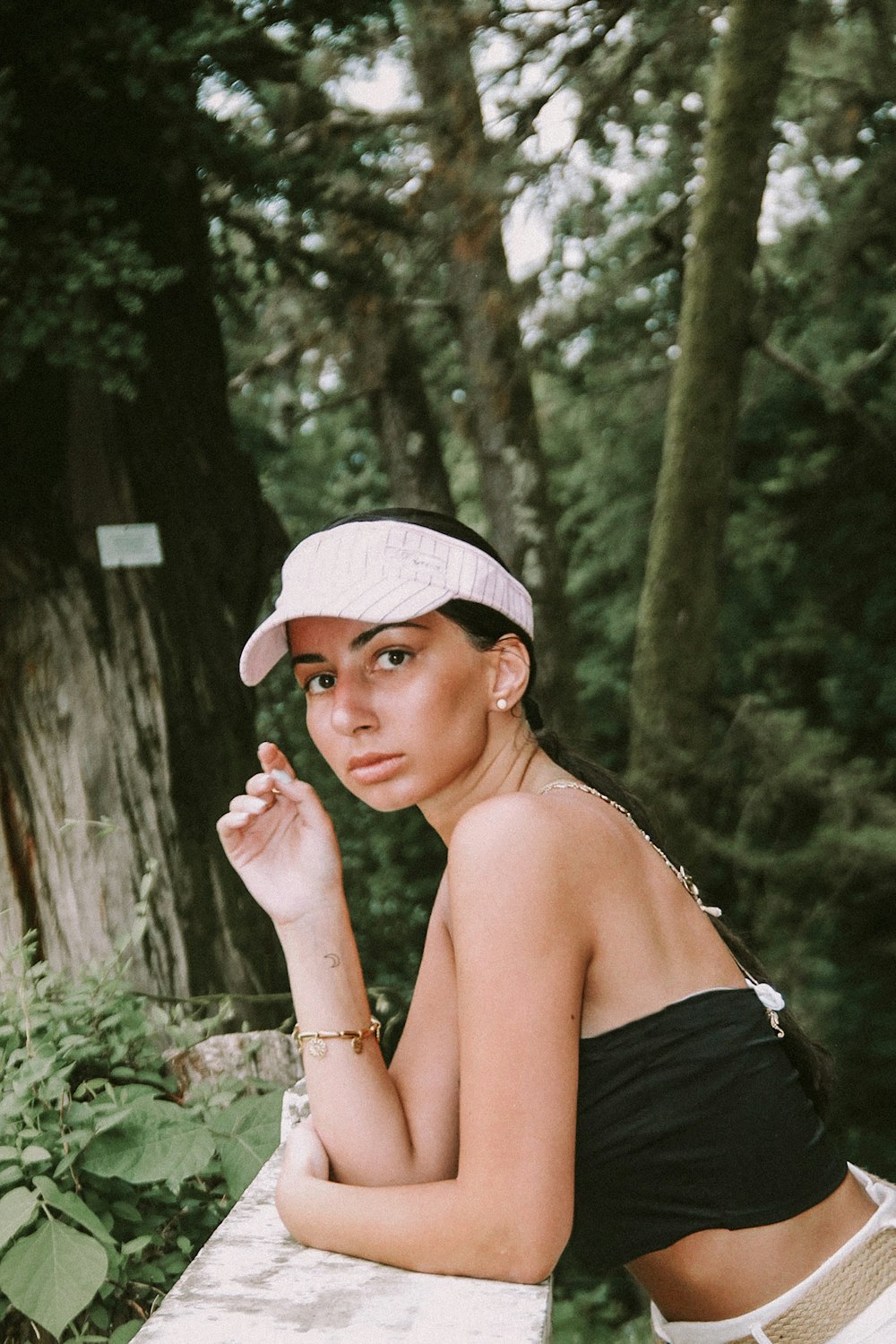 woman in black tube top wearing white hat