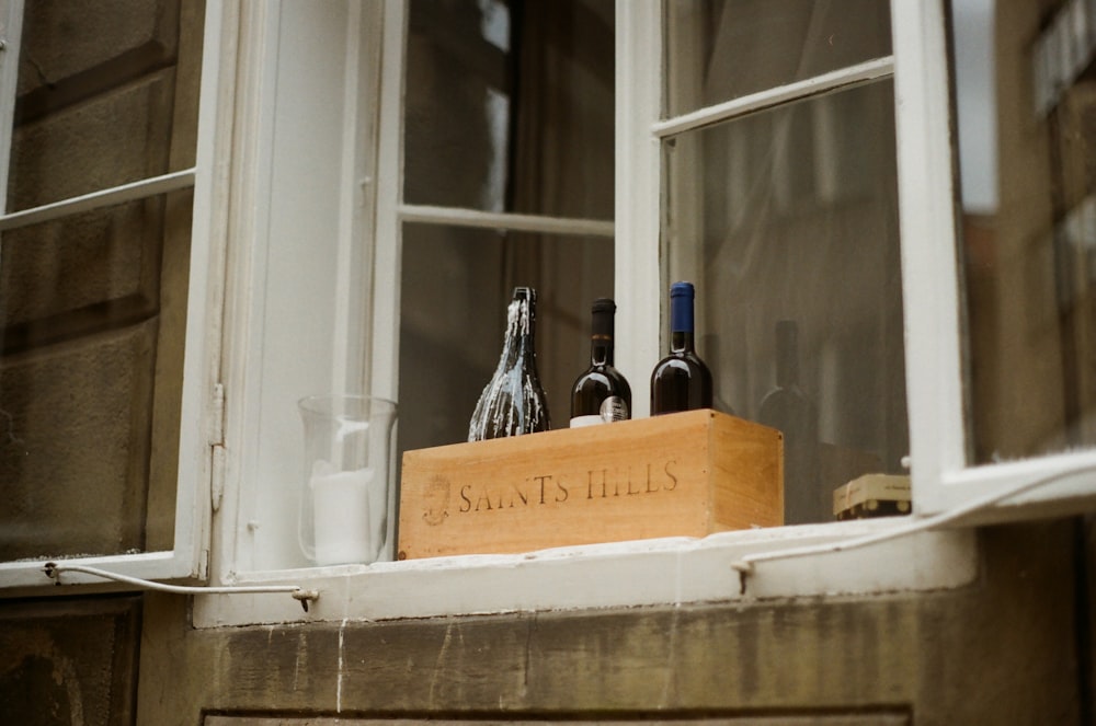 three bottles on brown wooden box