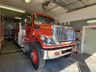 A friendly technician inspecting an automatic fire sprinkler system in a modern garage.