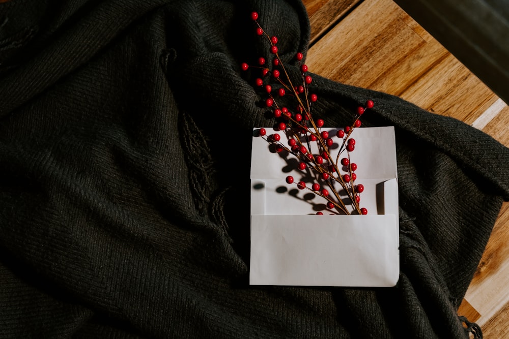 red and white beaded necklace on white paper