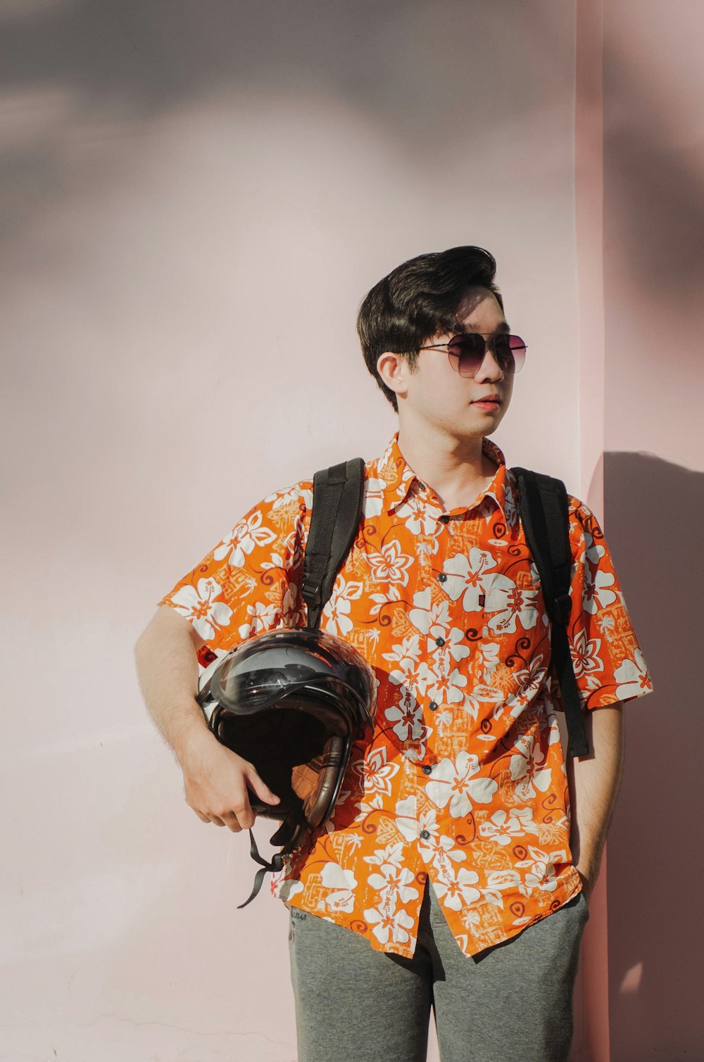 boy in orange and yellow floral button up t-shirt wearing black headphones