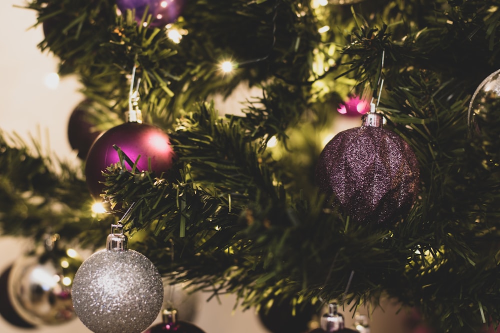 silver christmas baubles on green christmas tree