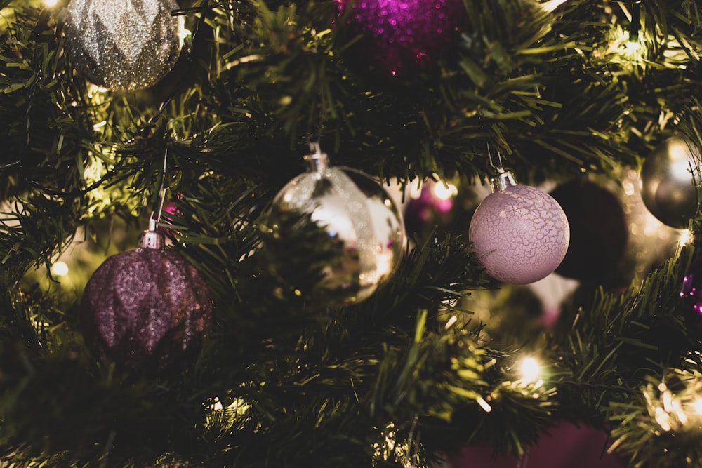 silver and purple baubles on green christmas tree