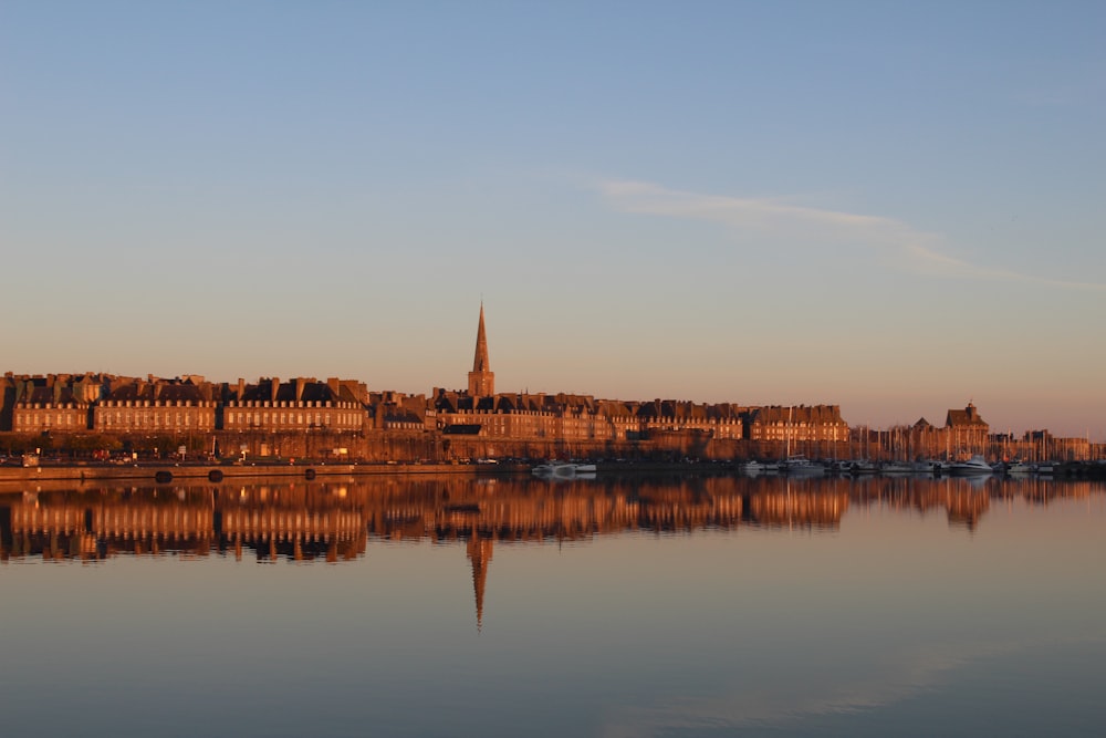 body of water near city buildings during daytime