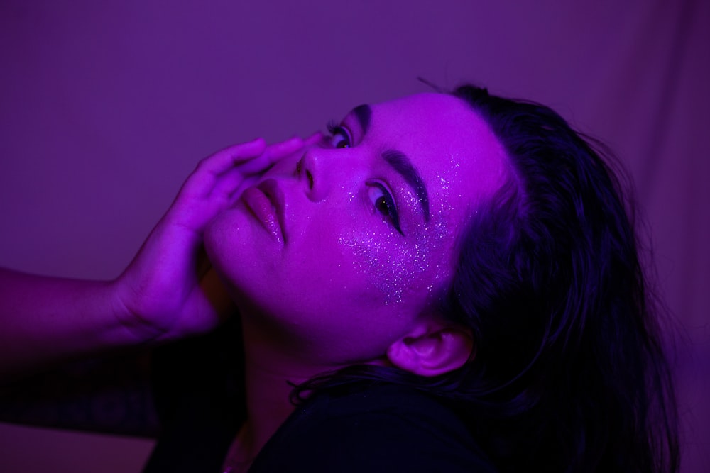 woman in black shirt with purple paint on face