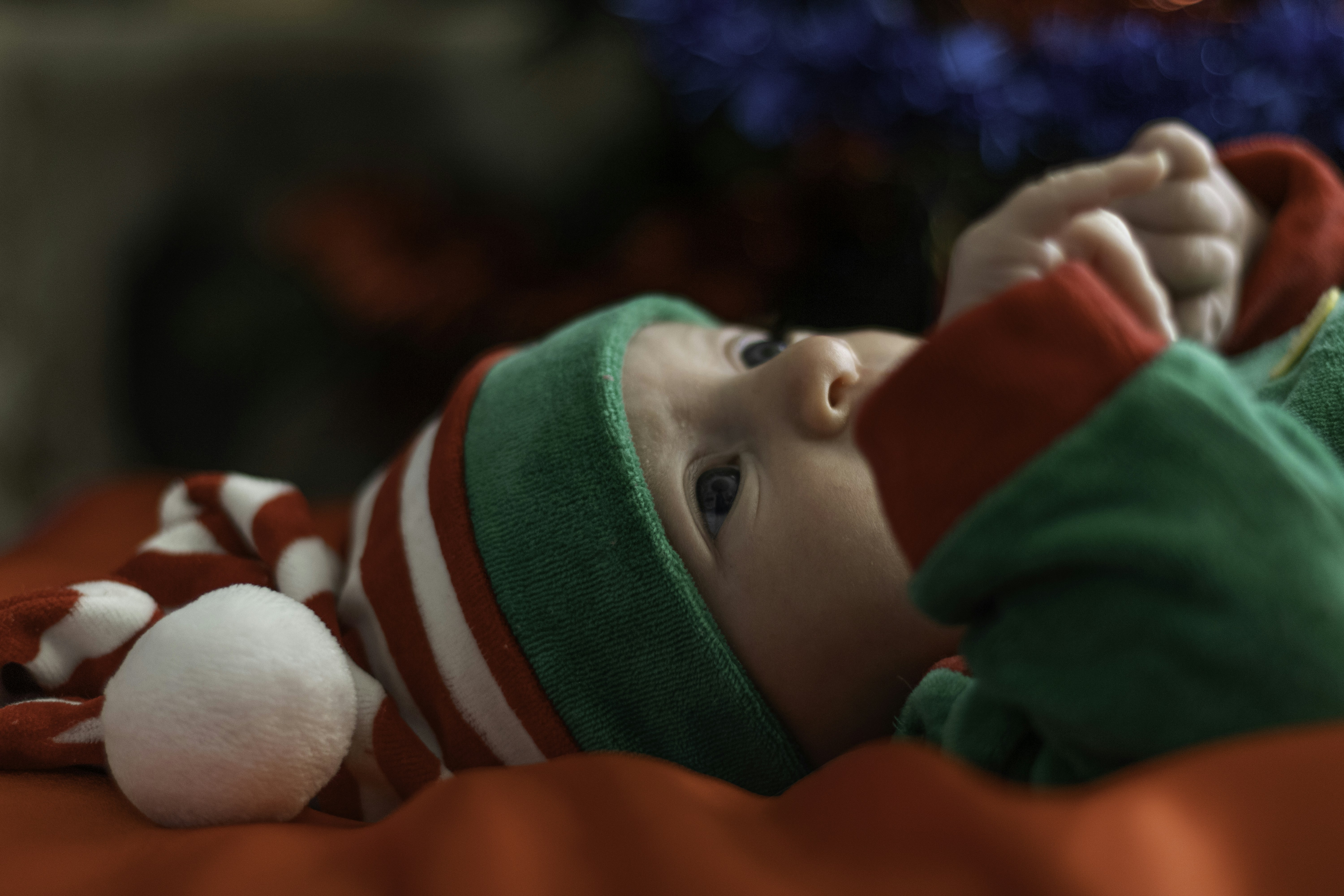 baby in green and white knit cap