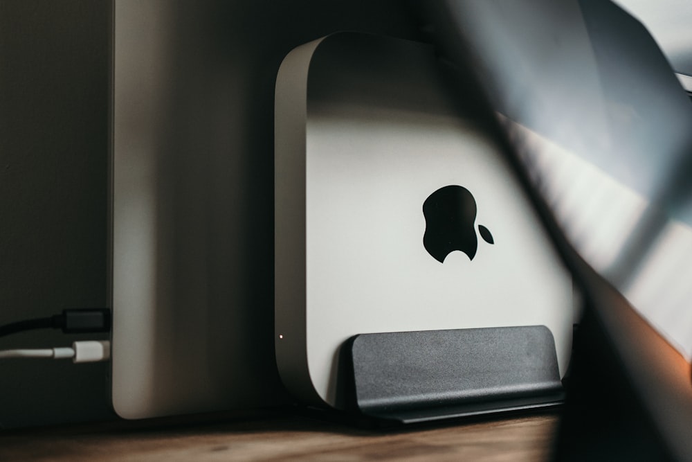 silver mac mini on brown wooden table