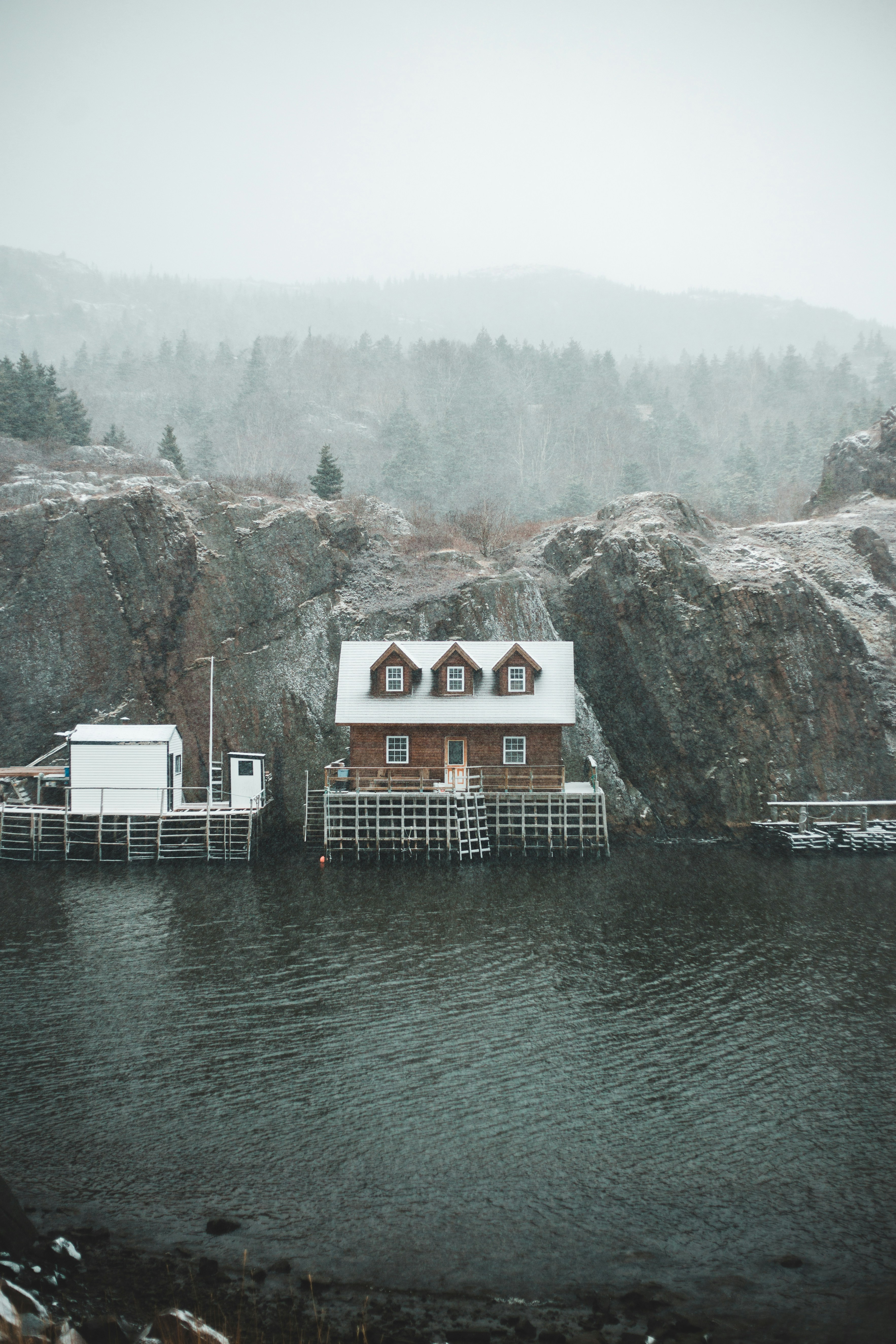 White and brown wooden house near body of water during daytime photo ...