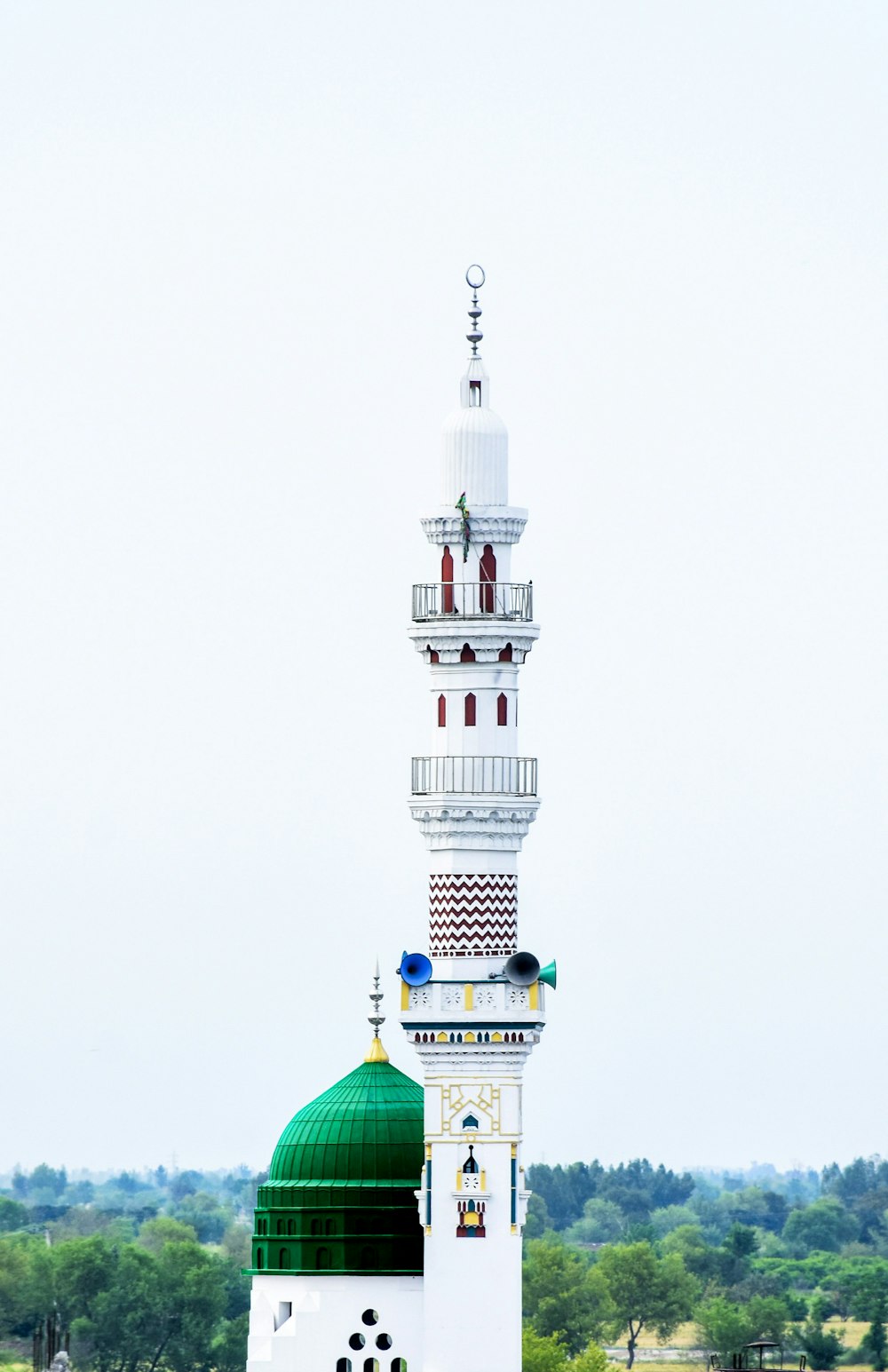 a tall white building with a green dome