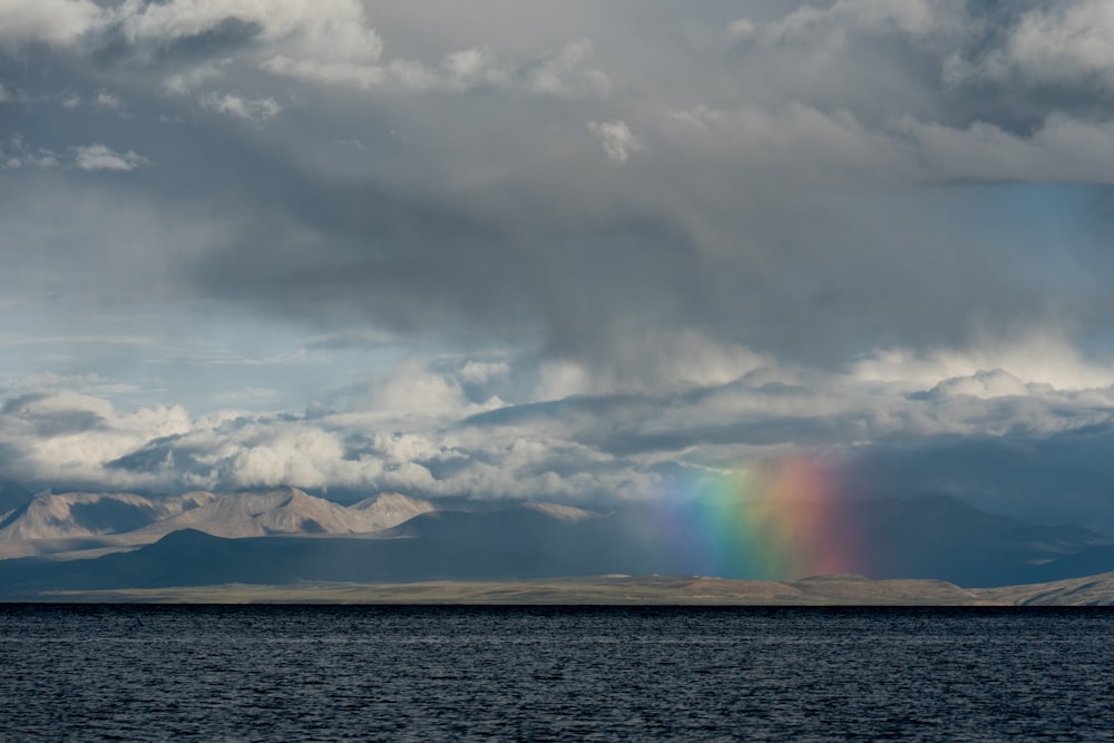 sea under white clouds during daytime