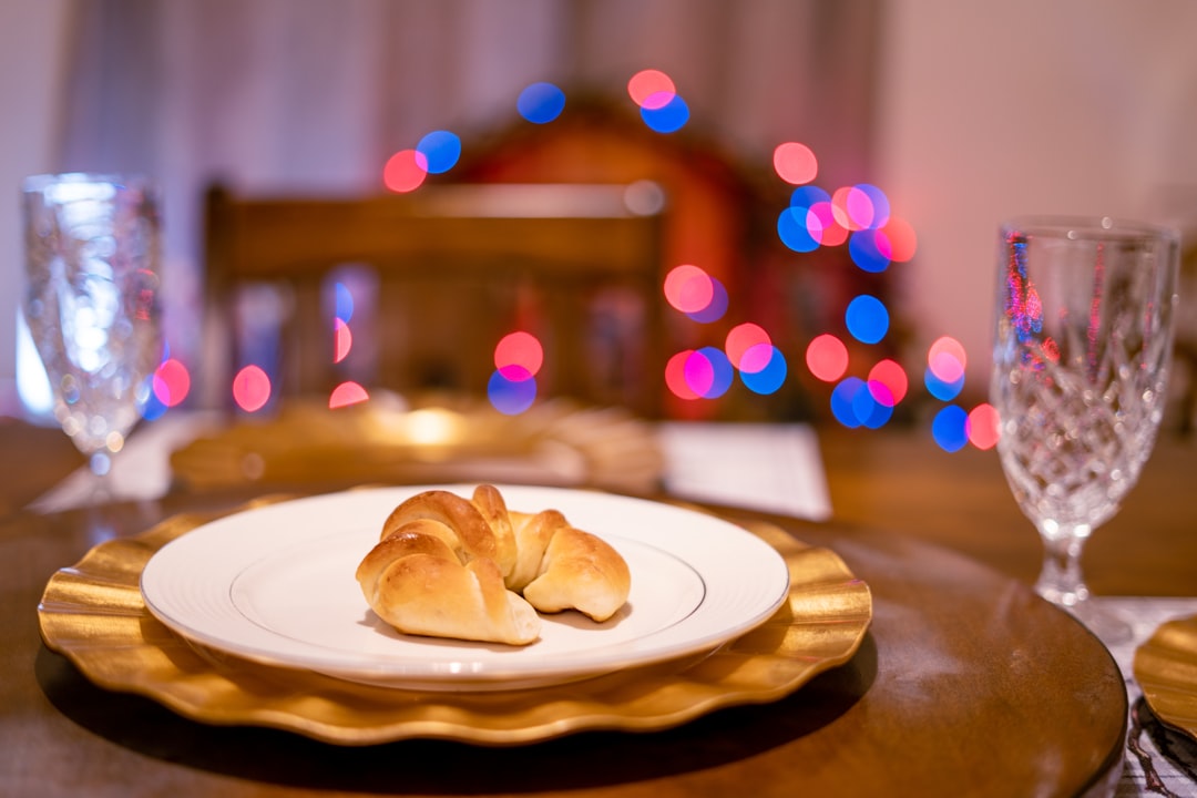 a croissant sitting on a plate on a table,