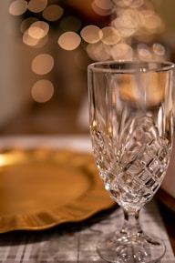 Close-up of elegant glassware catching the light on a festive table.