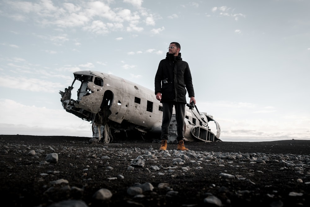 a man standing next to an old airplane