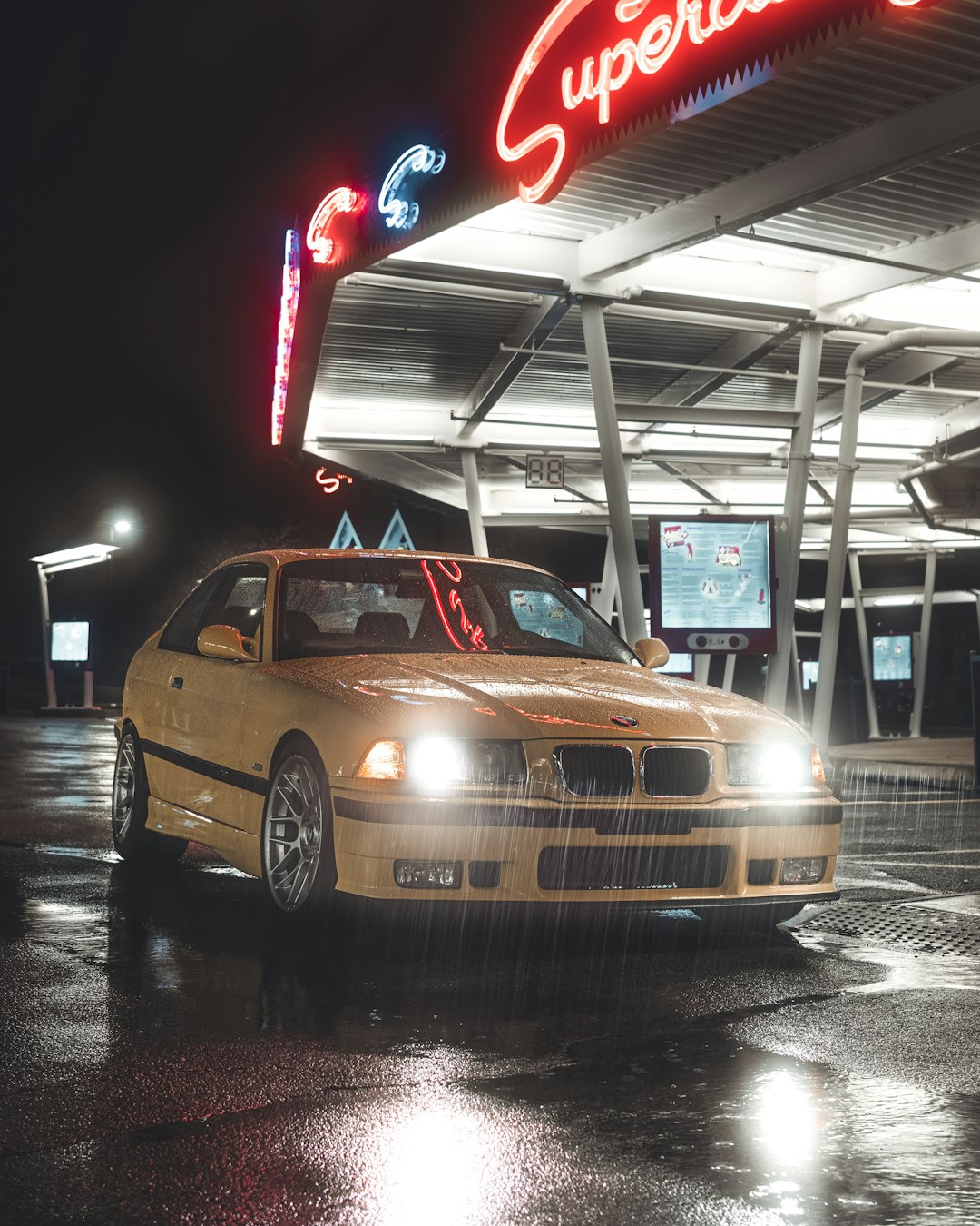 yellow bmw m 3 parked on parking lot during night time