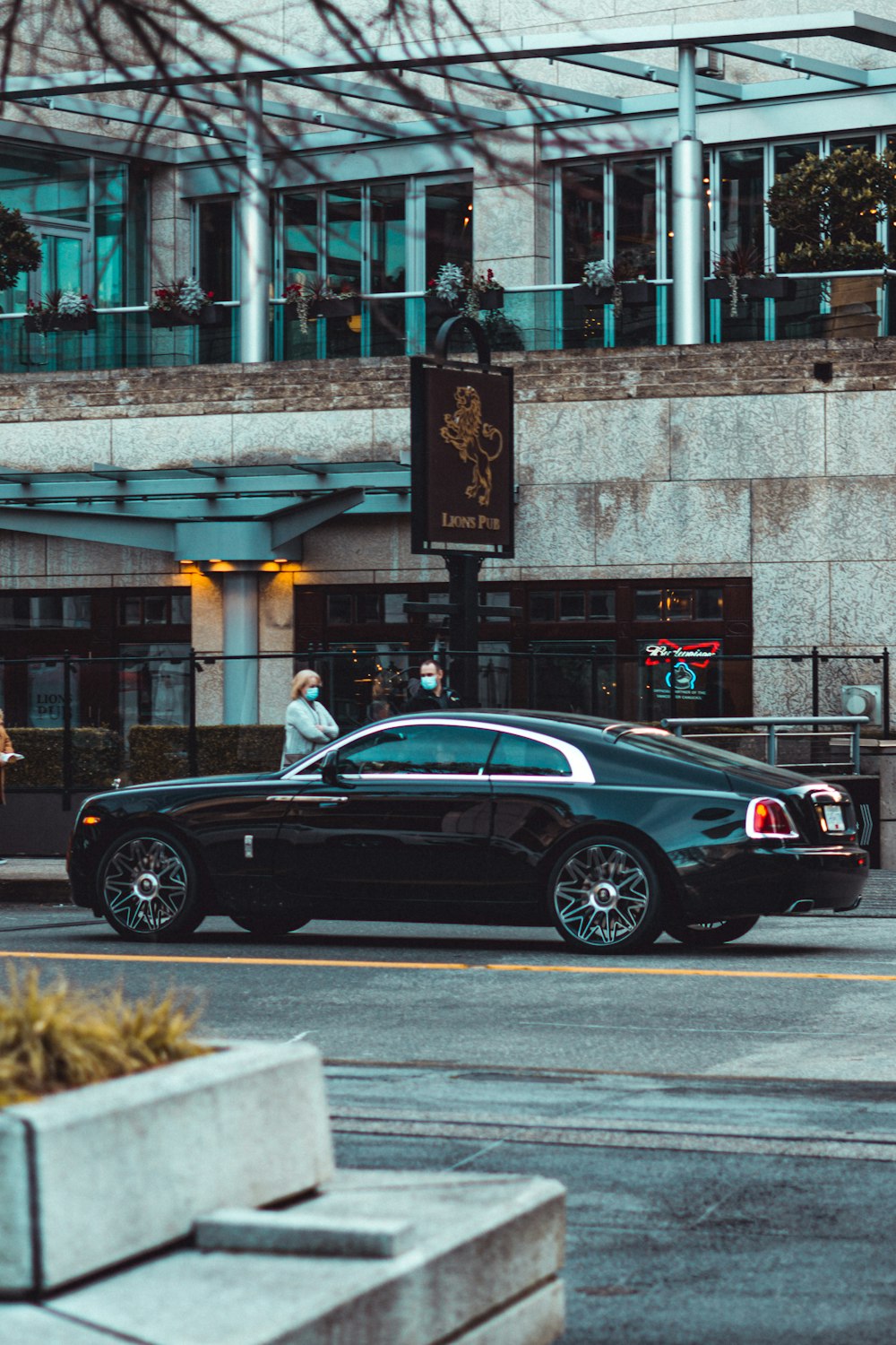 black sedan on road near building during daytime