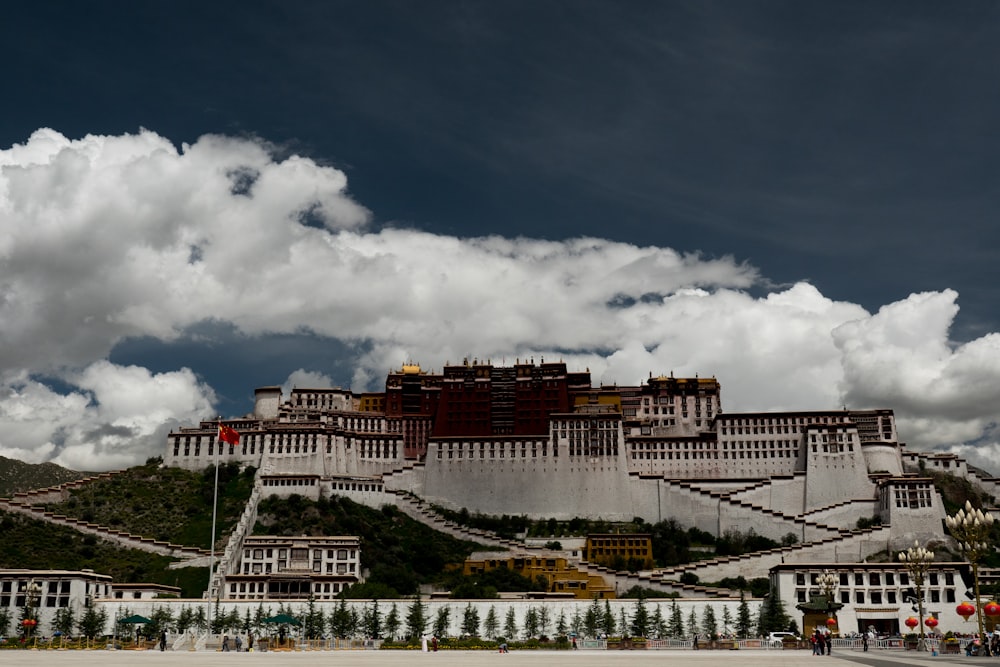 white and brown concrete building under white clouds during daytime