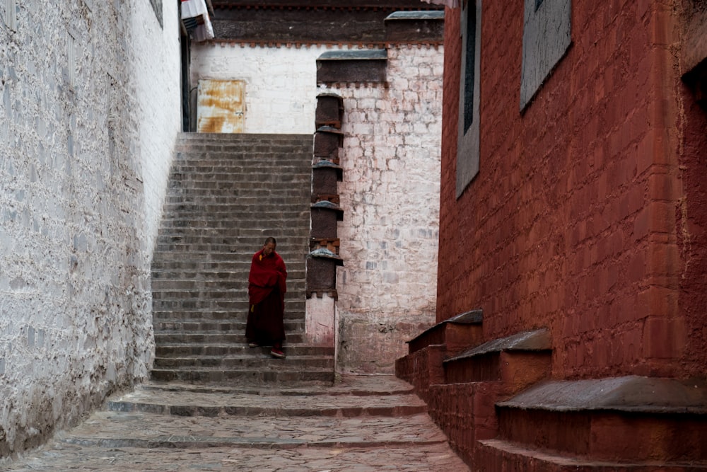 woman in red dress standing on stairs