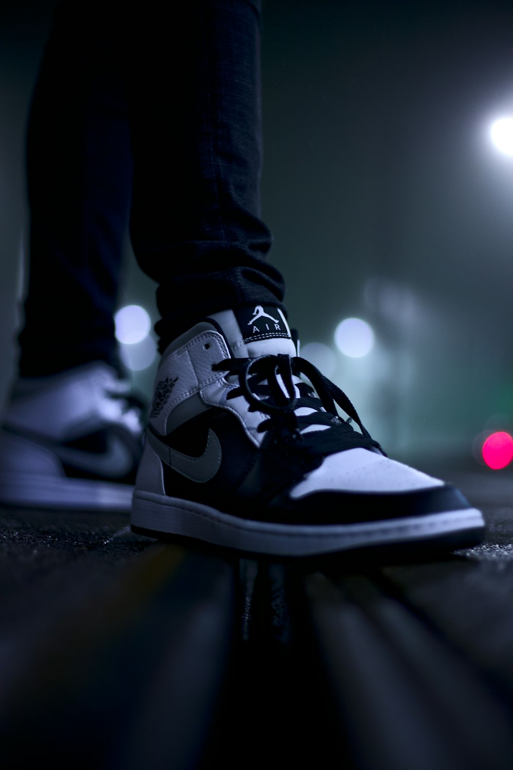 person wearing black and white nike high top sneakers